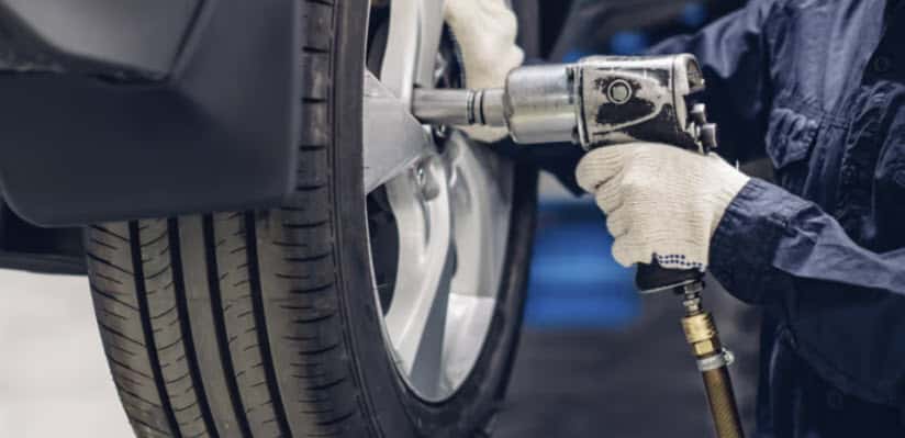 Certified Honda technician replacing winter tires during service at Zeigler Honda of Racine