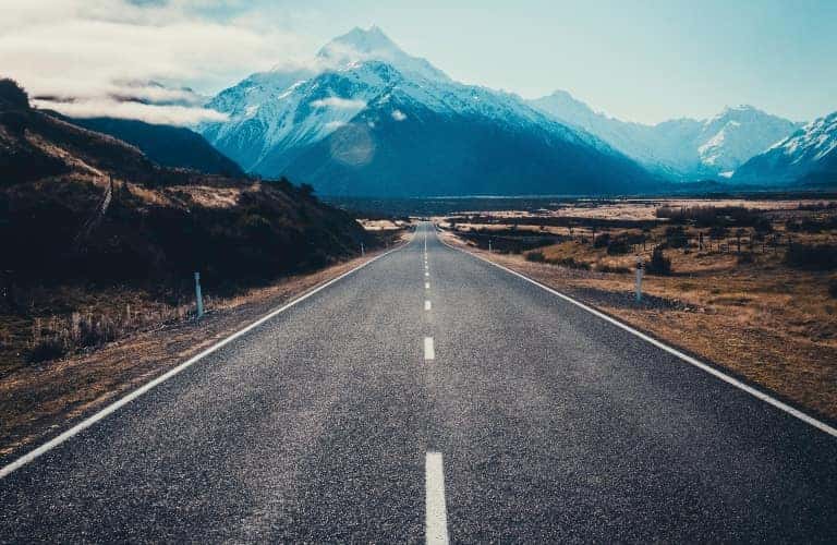 empty highway leading to mountain