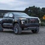 Front 7/8 view of GMC Canyon Denali from passenger's side perspective.