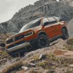 A Honda Passport driving off-road down a rocky hill.