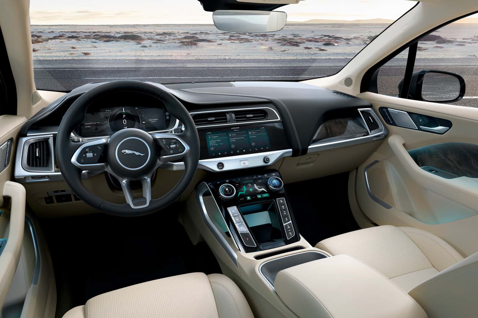 Steering wheel and dashboard view of Jaguar I-PACE interior with digital displays