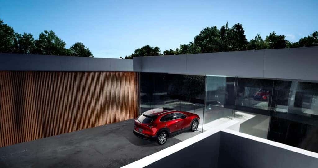 2025-Mazda-CX-30-Parked-outside-of-a-modern-style-home-made-of-wood-concrete-and-glass