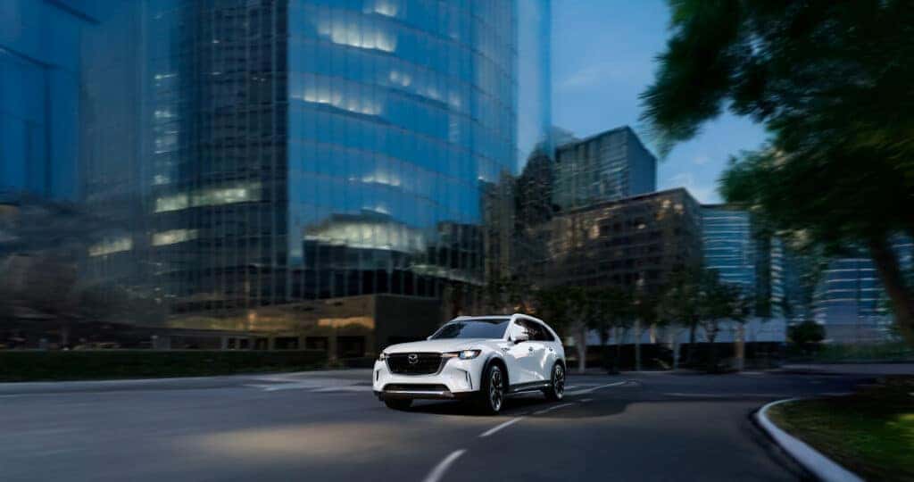 2025 Mazda CX-90 Cornering while drive down the road in a city