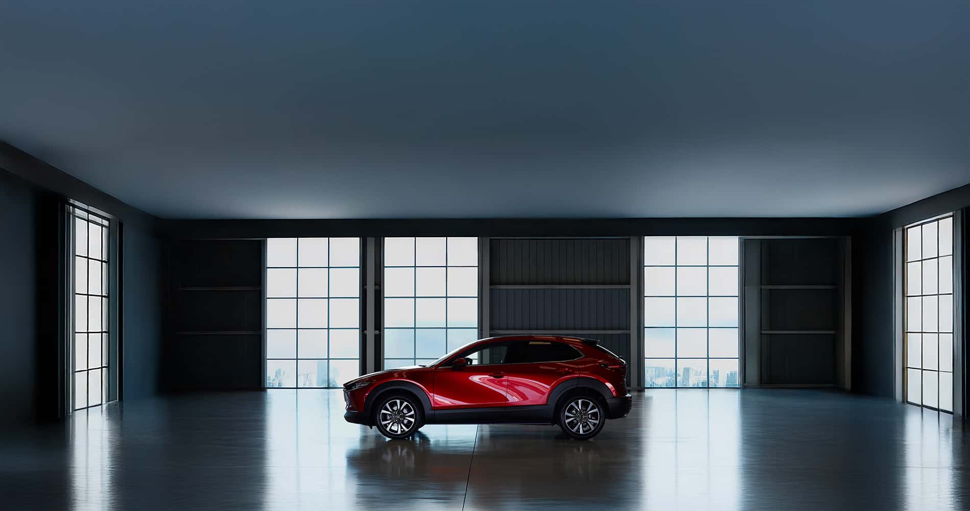 2025 Mazda CX-30 parked in a room with windows overlooking a cityscape