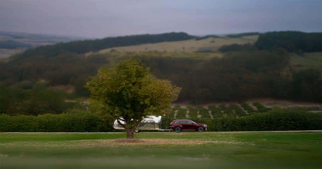2025-Mazda-CX-90-towing-capacity-of-a-camper-driving-through-the-Georgia-hills