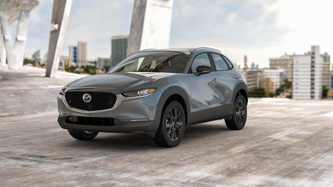2026 MAZDA CX‑30 2.5 S CARBON EDITION package parked in a concrete structure with city in background