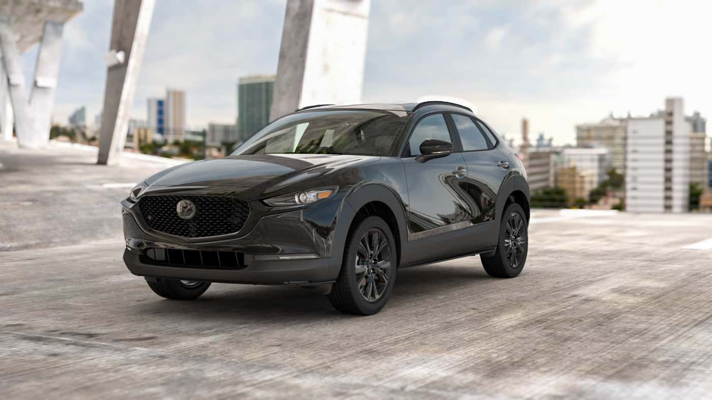 2026 MAZDA CX‑30 2.5 S package parked in a concrete structure with city in background