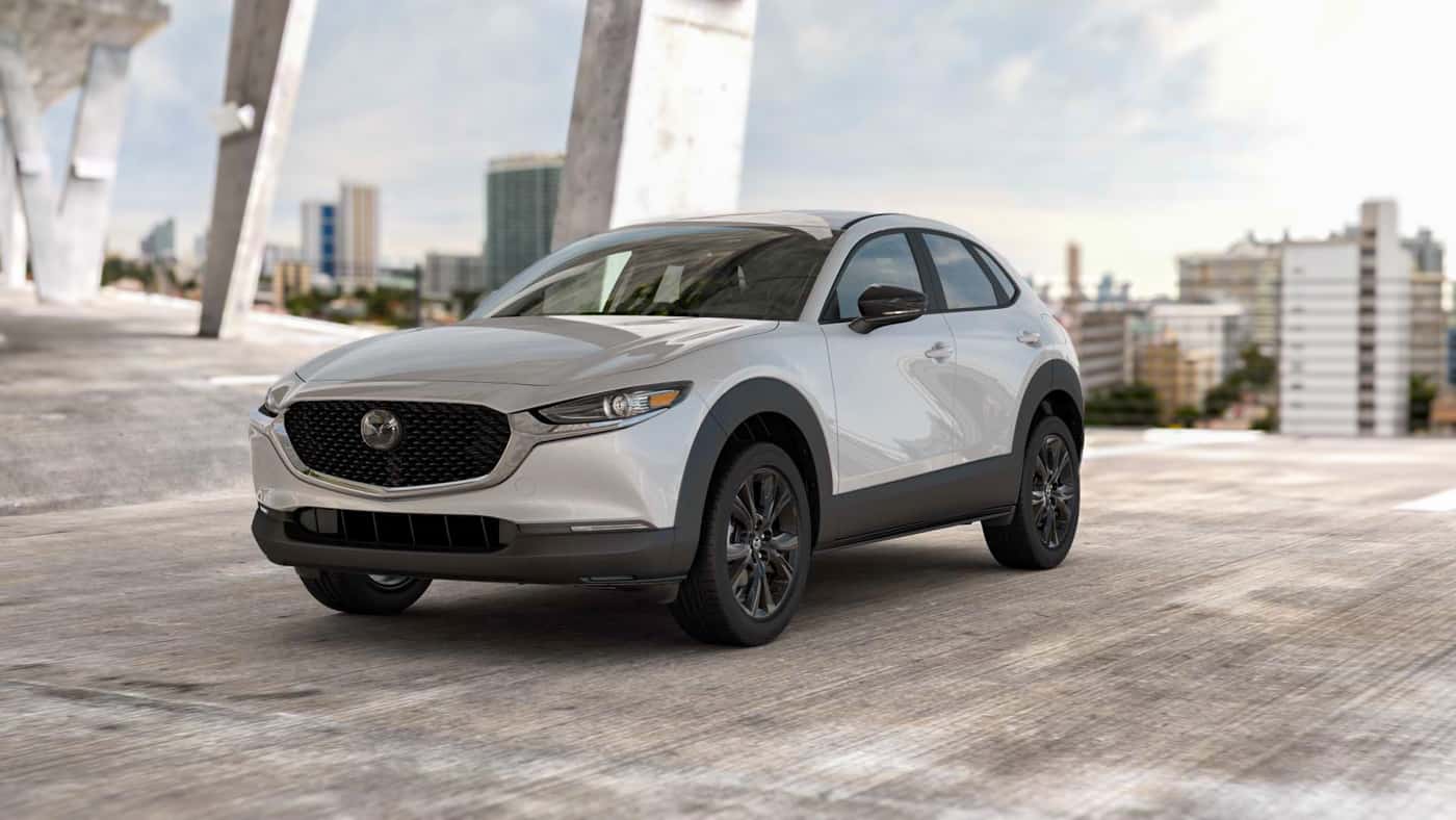 2026 MAZDA CX‑30 2.5 Select Sport package parked in a concrete structure with city in background