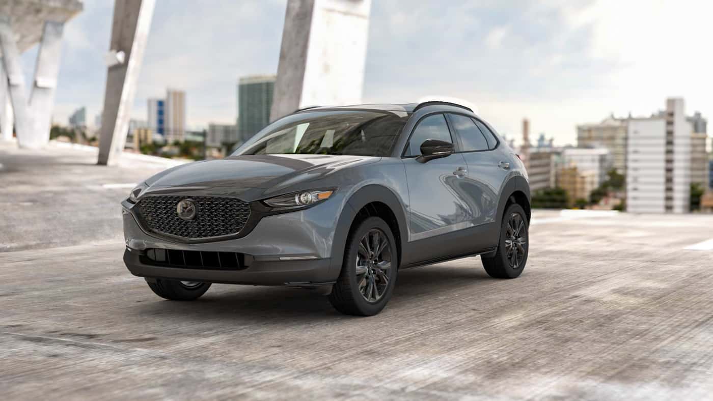 2026 MAZDA CX‑30 2.5 TURBO PREMIUM PLUS package parked in a concrete structure with city in background