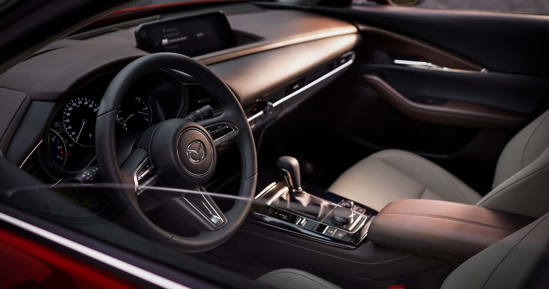 2026 Mazda CX-30 interior view of the dash and front seats in white leather