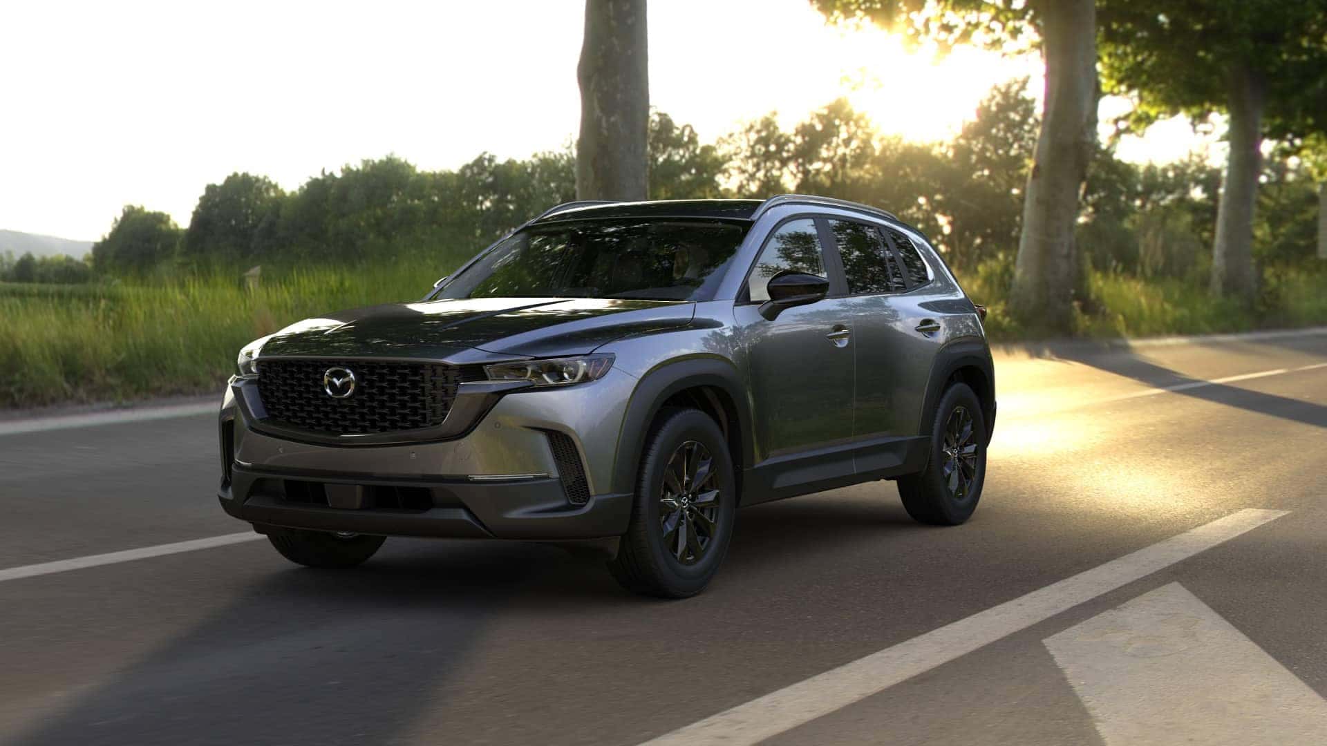 2026 Mazda CX‑50 2.5 S Preferred trim level riving down a sunny countryside highway