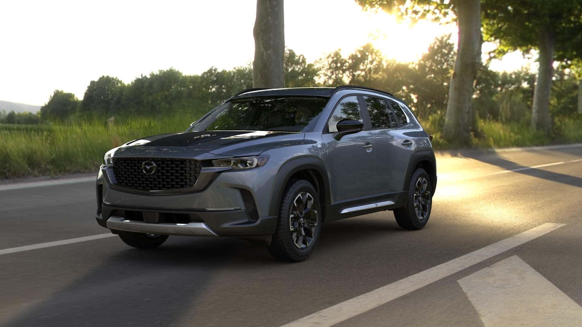 2026 Mazda CX‑50 2.5 Turbo Meridian Edition trim level riving down a sunny countryside highway