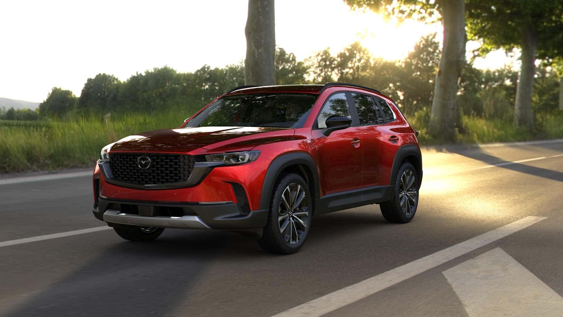 2026 Mazda CX‑50 2.5 Turbo trim level riving down a sunny countryside highway