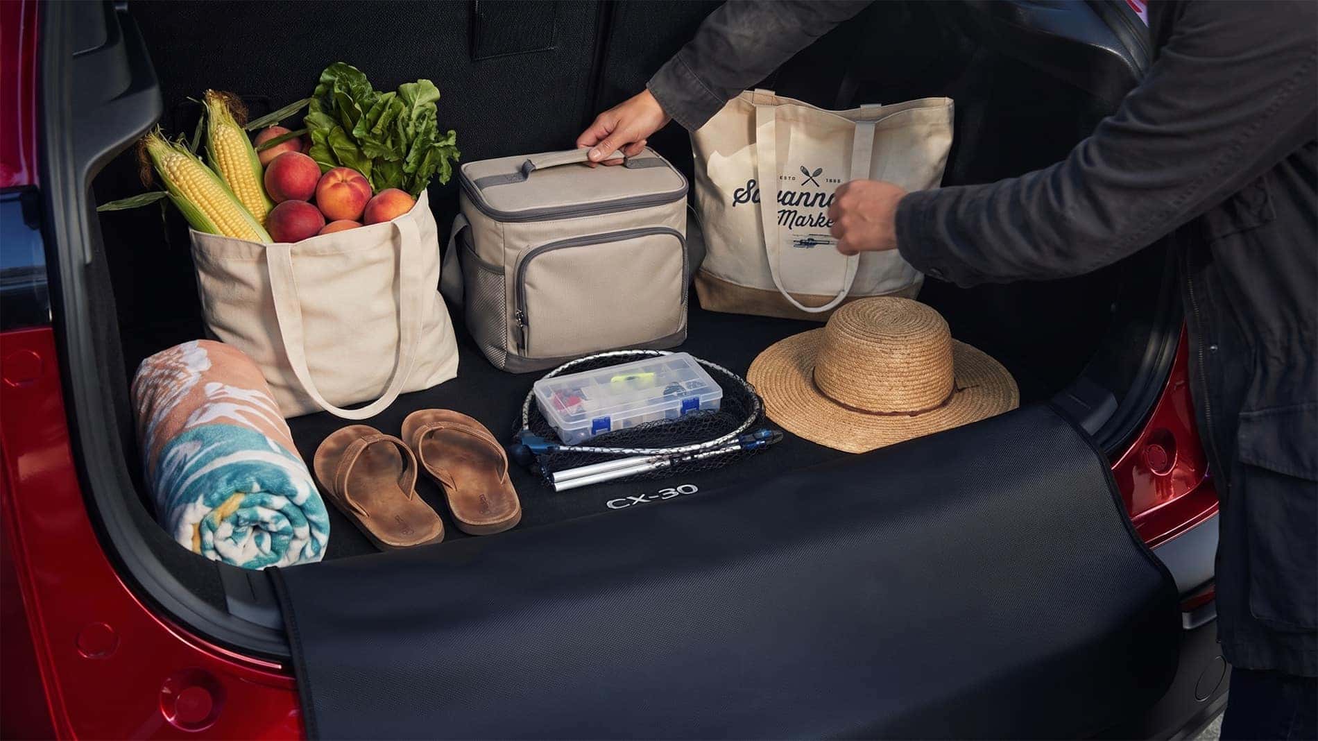 2026 Mazda CX-30 cargo space loaded with grocery tote, cooler bag, beach towel, sandals, straw hat, and fishing gear arranged for everyday Lowcountry use
