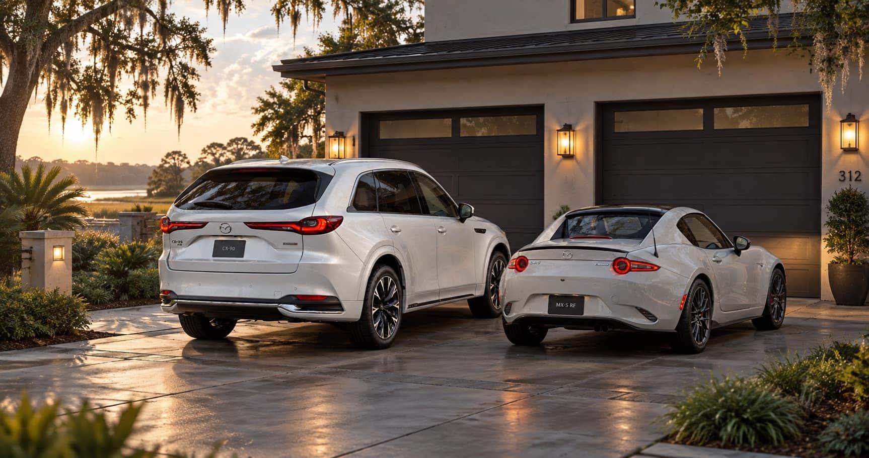 Mazda CX-90 and MX-5 Miata RF parked in the driveway of a home at sunset in Savannah, GA