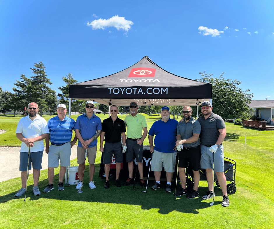 Toyota and Ford team in front of the Toyota tent at ALERT Golf tournament