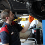 Quick lube technician looking at a car on a lift