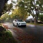 2026 Toyota BZ4X driving through a neighborhood