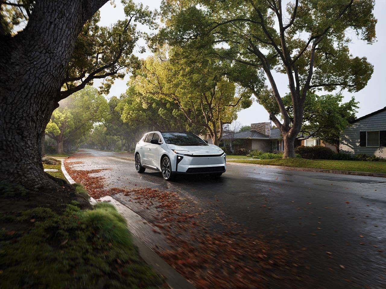 2026 Toyota BZ4X driving through a neighborhood
