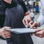 Stock image of a mechanic going over service that had been done on a customer vehicle