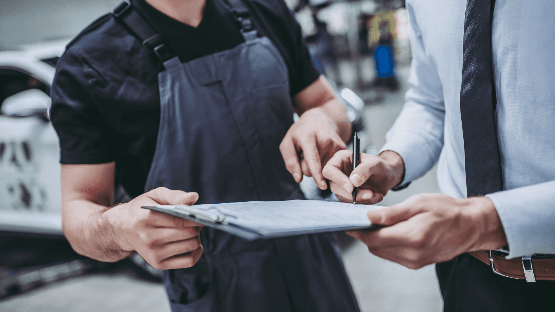 Stock image of a mechanic going over service that had been done on a customer vehicle