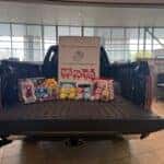 Some donated toys on the back of a Toyota Tundra in the Kalispell Toyota showroom for the Kalispell Auto Group Toys for Tots drive.