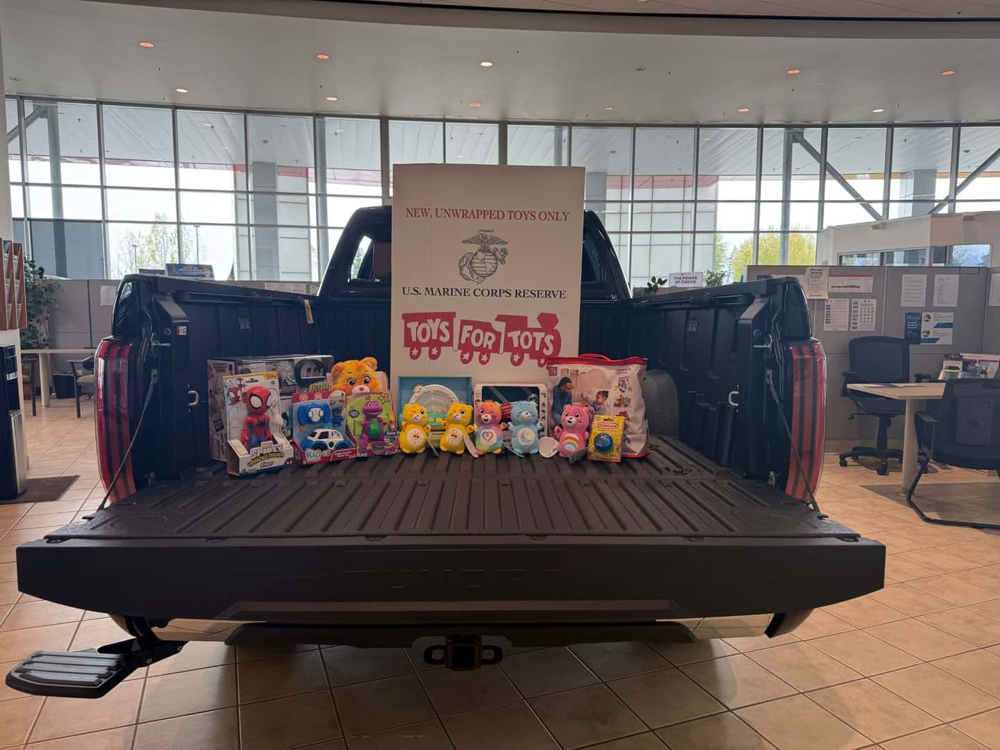 Some donated toys on the back of a Toyota Tundra in the Kalispell Toyota showroom for the Kalispell Auto Group Toys for Tots drive. 