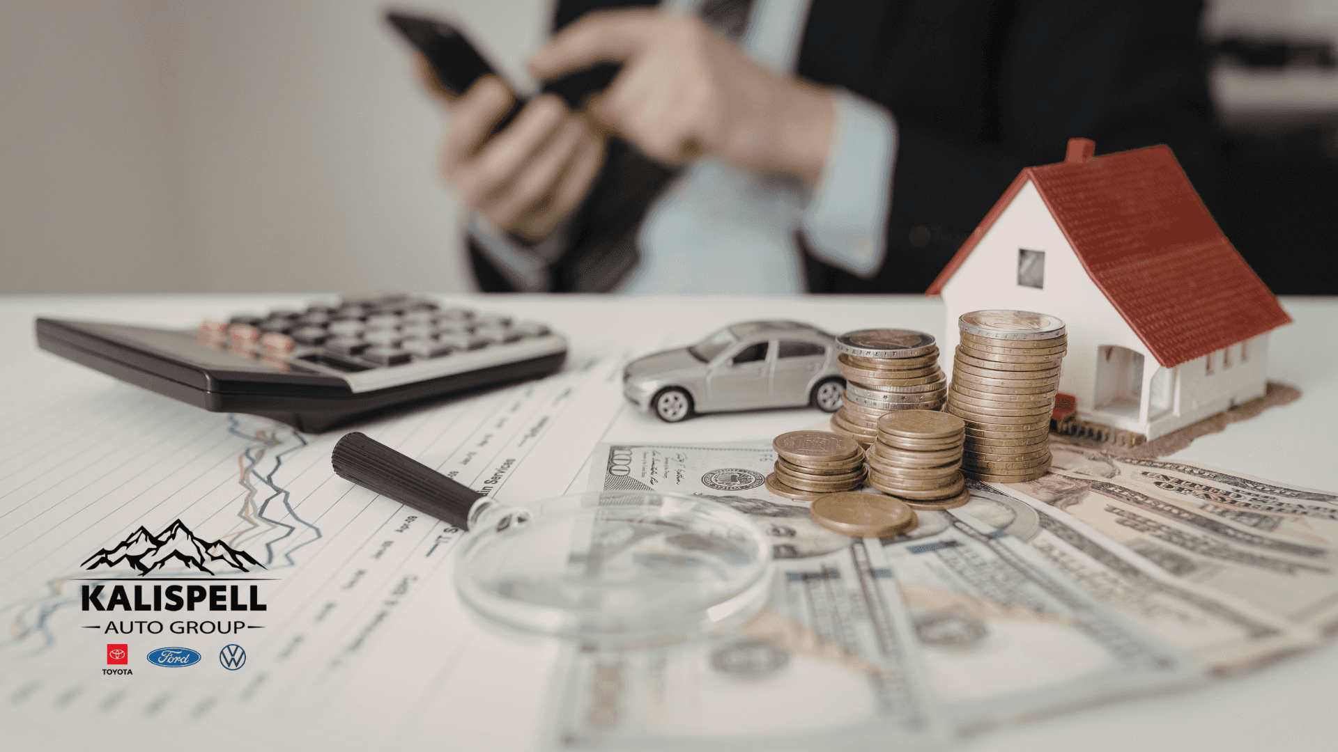 Car financing concept with calculator, cash, coins, and model car showing credit score and auto loan planning