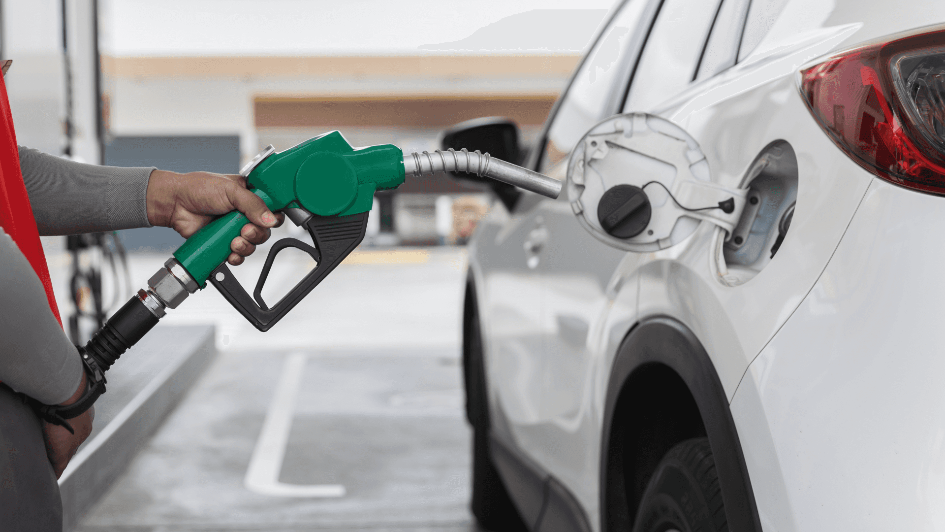 Stock image of someone fueling up a car
