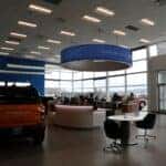 The Kalispell Ford Showroom on a rainy day in the Flathead Valley. A Ford Bronco Sport sits off to the left.