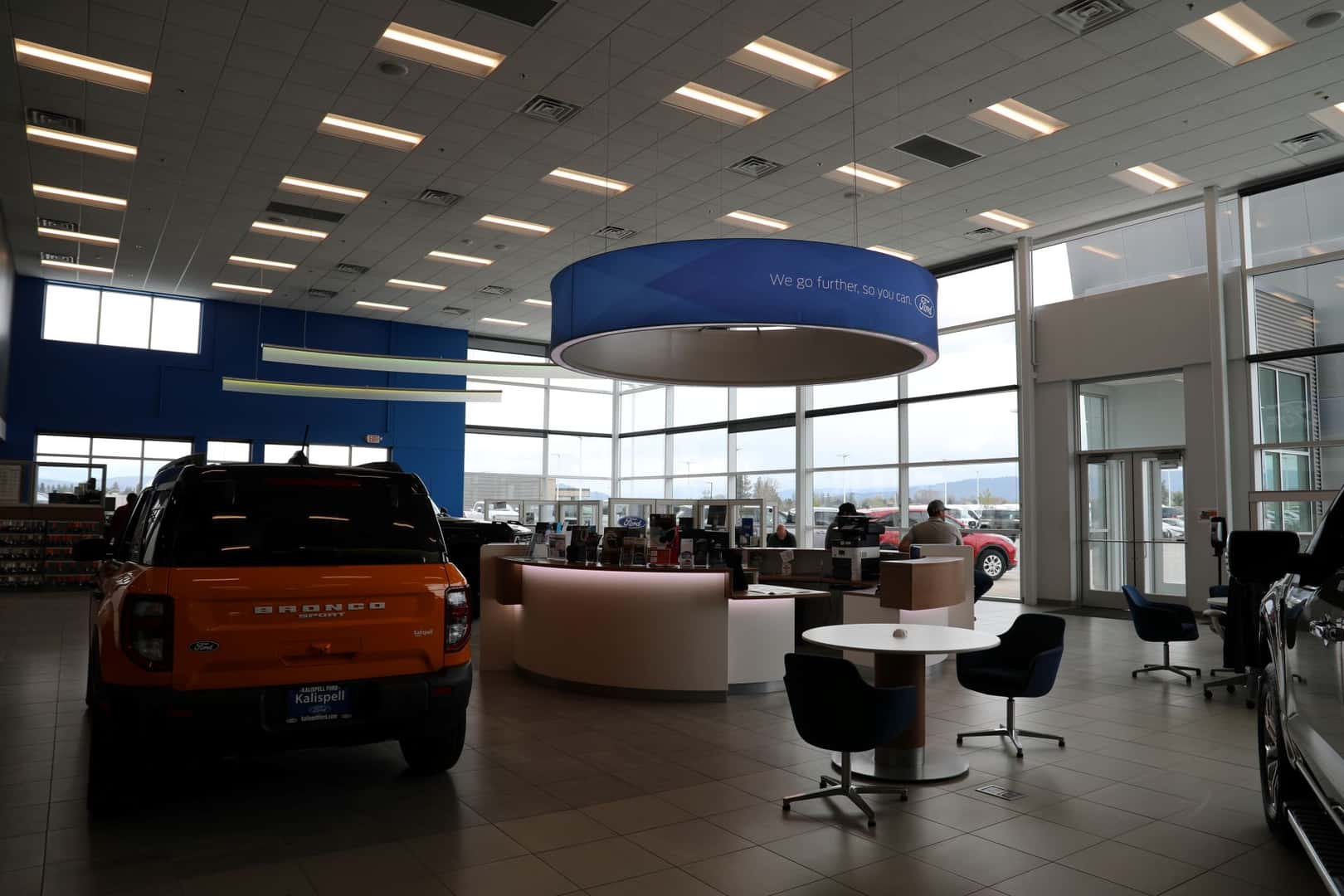 The Kalispell Ford Showroom on a rainy day in the Flathead Valley. A Ford Bronco Sport sits off to the left.