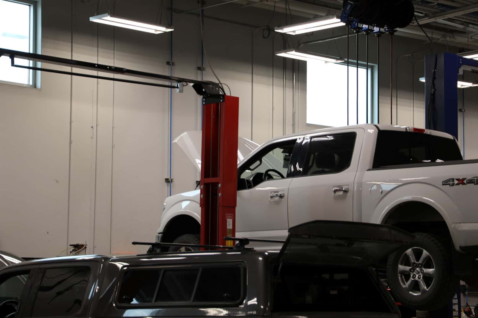 Ford truck on the lift and being worked on at Kalispell Ford