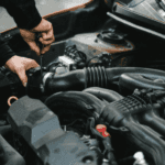 Stock image of a person working on a vehicles engine