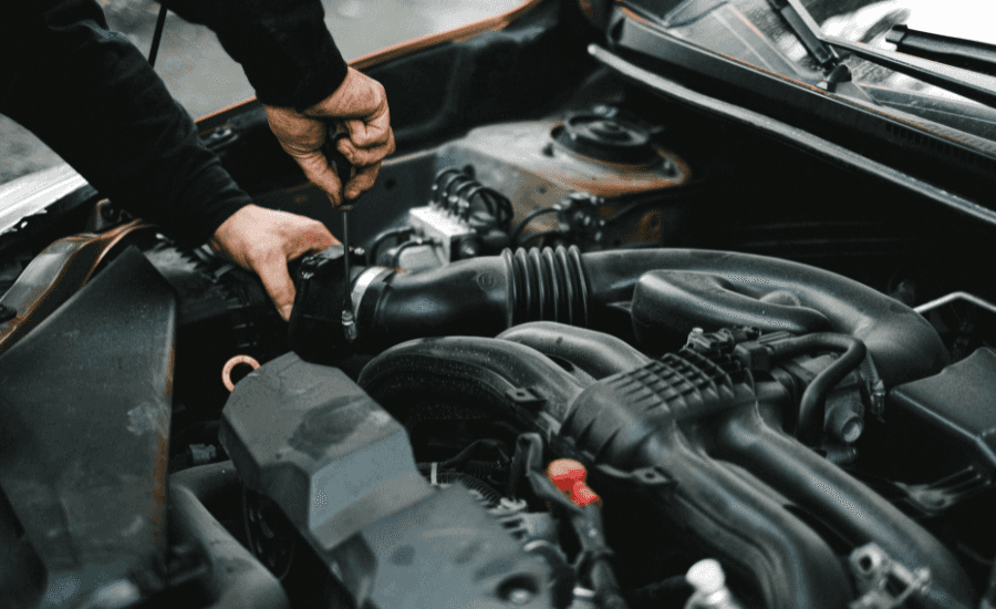 Stock image of a person working on a vehicles engine