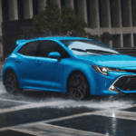 blue corolla hatchback in the rain driving on a city street