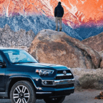 4Runner-sideview-man standing on a rock looking up at mountains