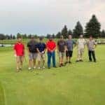 Kalispell Toyota employees golf team for company golf outing standing in line on the green at village greens golf course