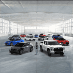 Toyota Hybrid and electric car lineup featuring 13 vehicles parked in a warehouse