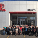 Employees standing in front of Kalispell Toyota dealership