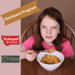girl eat mac and cheese from the backpack program