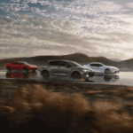 three Toyota vehicles driving down a highway