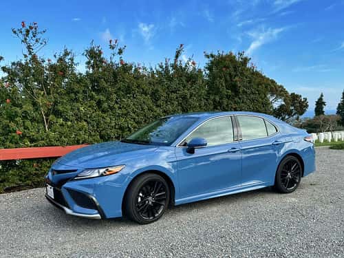 Blue car parked at the side of a road