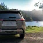 2026 Toyota Rav4 on the shore of a lake on a sunny day