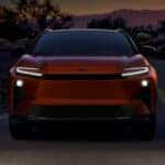 The all electric 2026 Toyota C-HR driving on a backroad