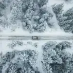 2026 Toyota Rav4 driving down a snowy backroad as seen from above