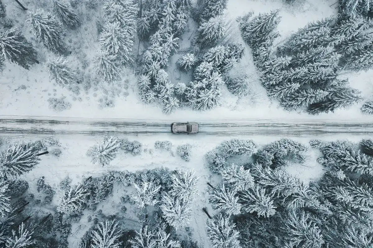 2026 Toyota Rav4 driving down a snowy backroad as seen from above