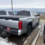 Silver Toyota Tundra on the Kalispell Toyota lot with a hard top tonnaeu cover