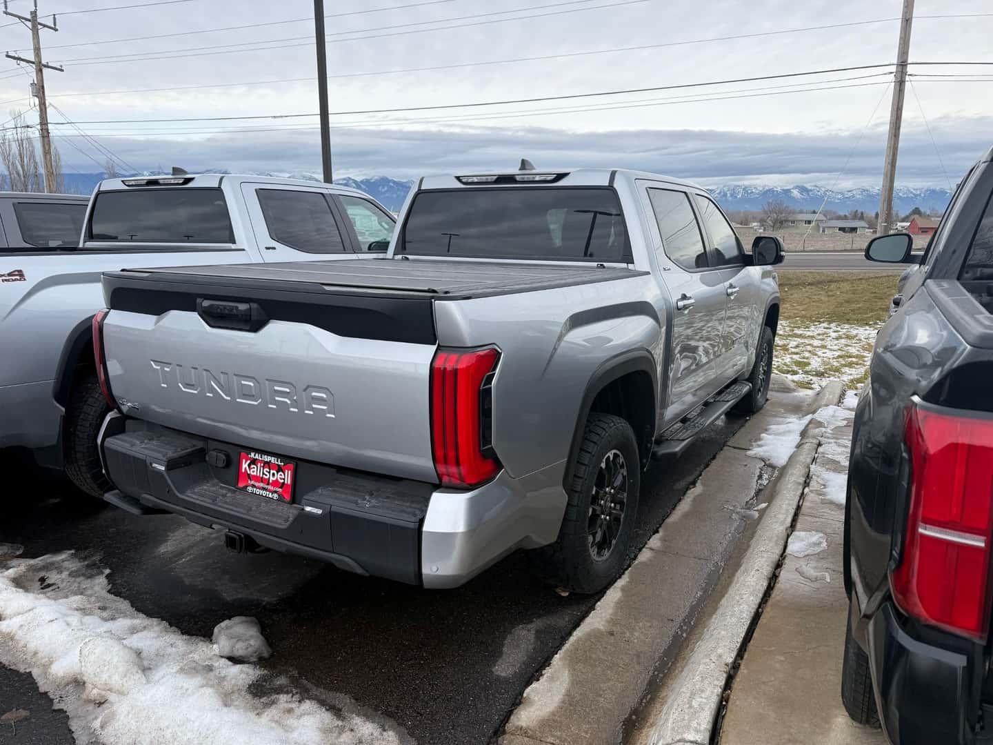 Silver Toyota Tundra on the Kalispell Toyota lot with a hard top tonnaeu cover