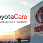 Toyota Emblem on the Kalispell Toyota building next to the Toyota Care logo