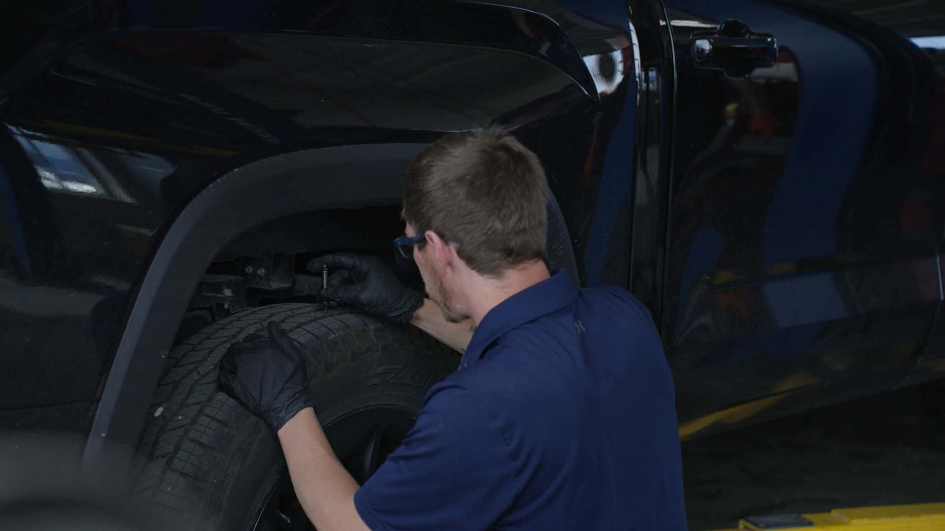 Kalispell Toyota certified technician inspecting tire tread